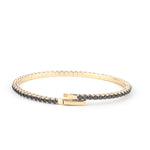 Elegant 14K gold tennis bracelet adorned with Onyx, featuring a secure clasp and a sleek design for a luxurious look."