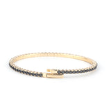 Elegant 14K gold tennis bracelet adorned with Onyx, featuring a secure clasp and a sleek design for a luxurious look."