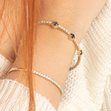 clover 14K Gold Black Onyx Flexible Bracelet , on wowen wrist with another bracelet