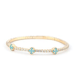 A stunning close-up of a turquoise crystal and 14K gold bracelet worn on a wrist, showcasing its refined elegance.