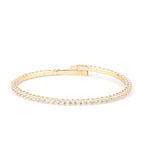 A refined gold diamond tennis bracelet with a secure clasp, displayed on a white background to highlight its brilliance.