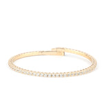 A refined gold diamond tennis bracelet with a secure clasp, displayed on a white background to highlight its brilliance.