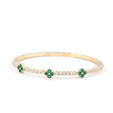 Elegant 14K gold tennis bracelet adorned with sparkling white and green gemstones in a clover design, perfect for refined everyday wear."