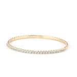 A close-up of a gold moissanite tennis bracelet, showcasing its radiant sparkle and timeless appeal against a neutral background.