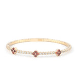 A luxurious 14K gold flexible bracelet featuring deep red ruby stones and sparkling moissanite diamonds, perfect for elegant women’s jewelry.