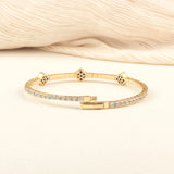 A beautifully handcrafted black onyx bracelet with a minimalist gold design, worn as a statement piece.