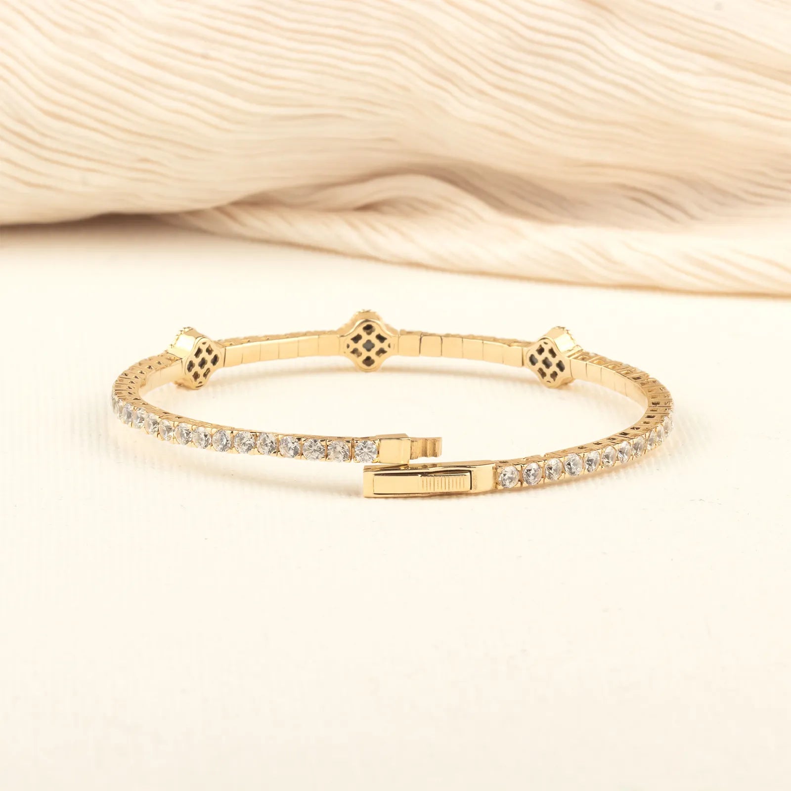 A beautifully handcrafted black onyx bracelet with a minimalist gold design, worn as a statement piece.