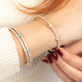 A minimalistic turquoise crystal bracelet crafted in 14K gold, offering a refined, sophisticated look.
