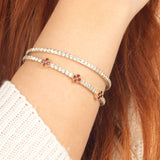A minimalist and elegant 14K gold flexible bracelet with premium ruby gemstones and moissanite accents, ideal for layering or standalone wear.