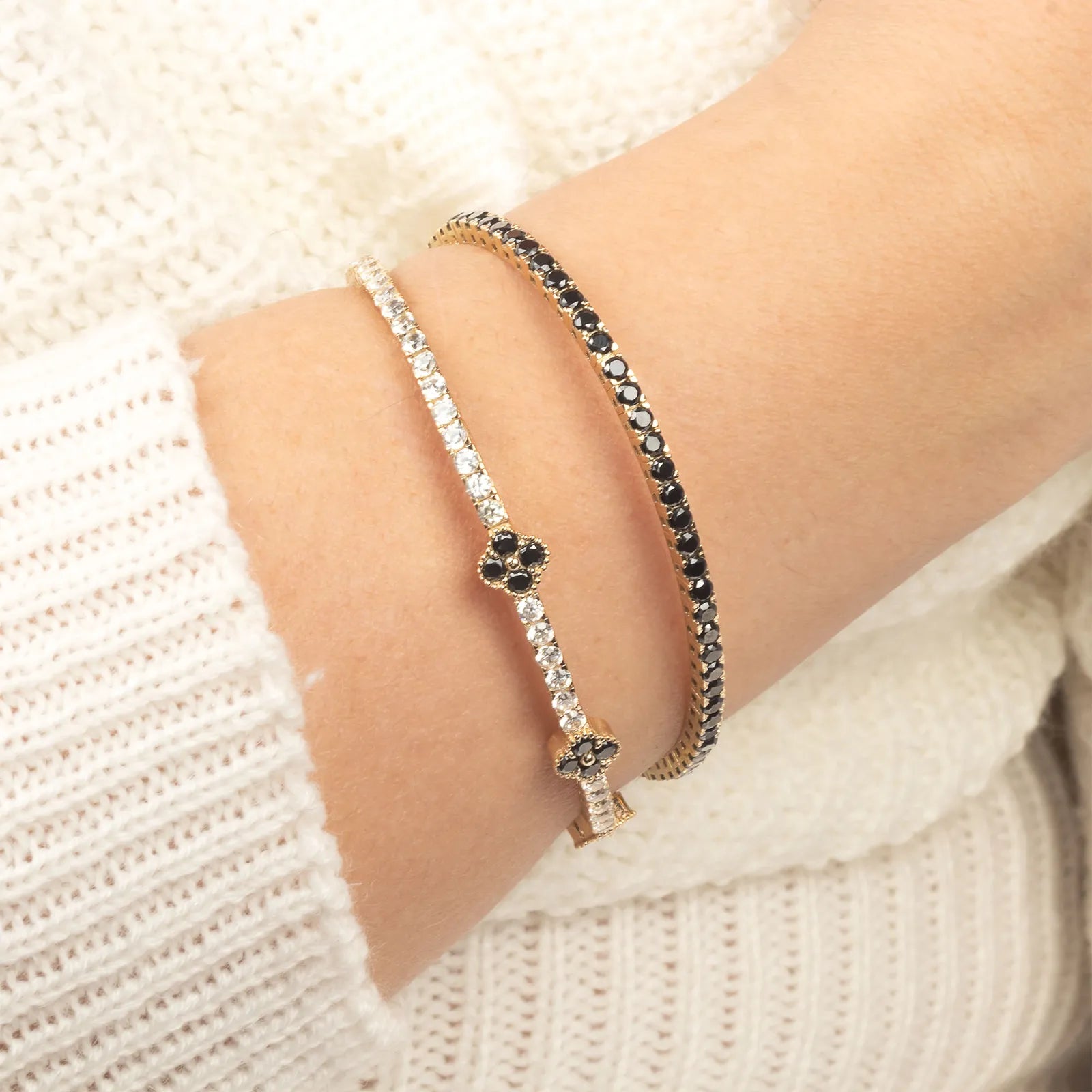 A luxurious 14K gold bangle adorned with black onyx stones, exuding elegance and refinement.