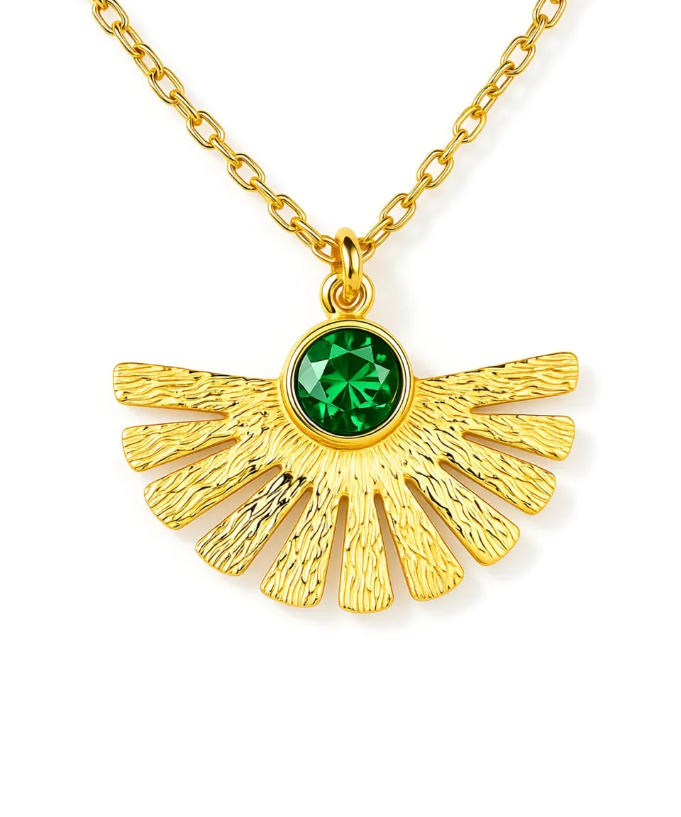 Gold necklace with a green gemstone pendant on a white background