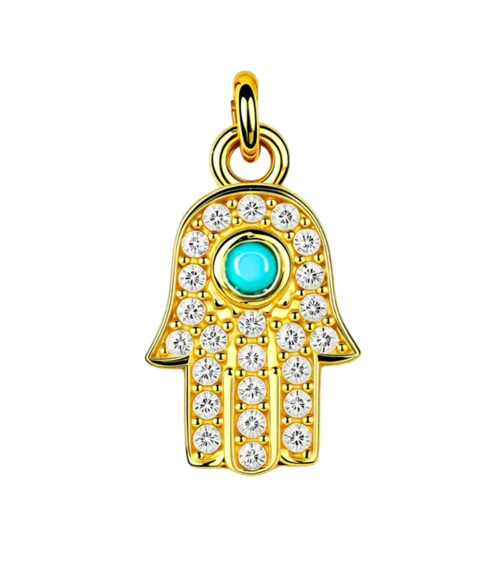 Gold Hamsa pendant with turquoise center and clear stones on a white background
