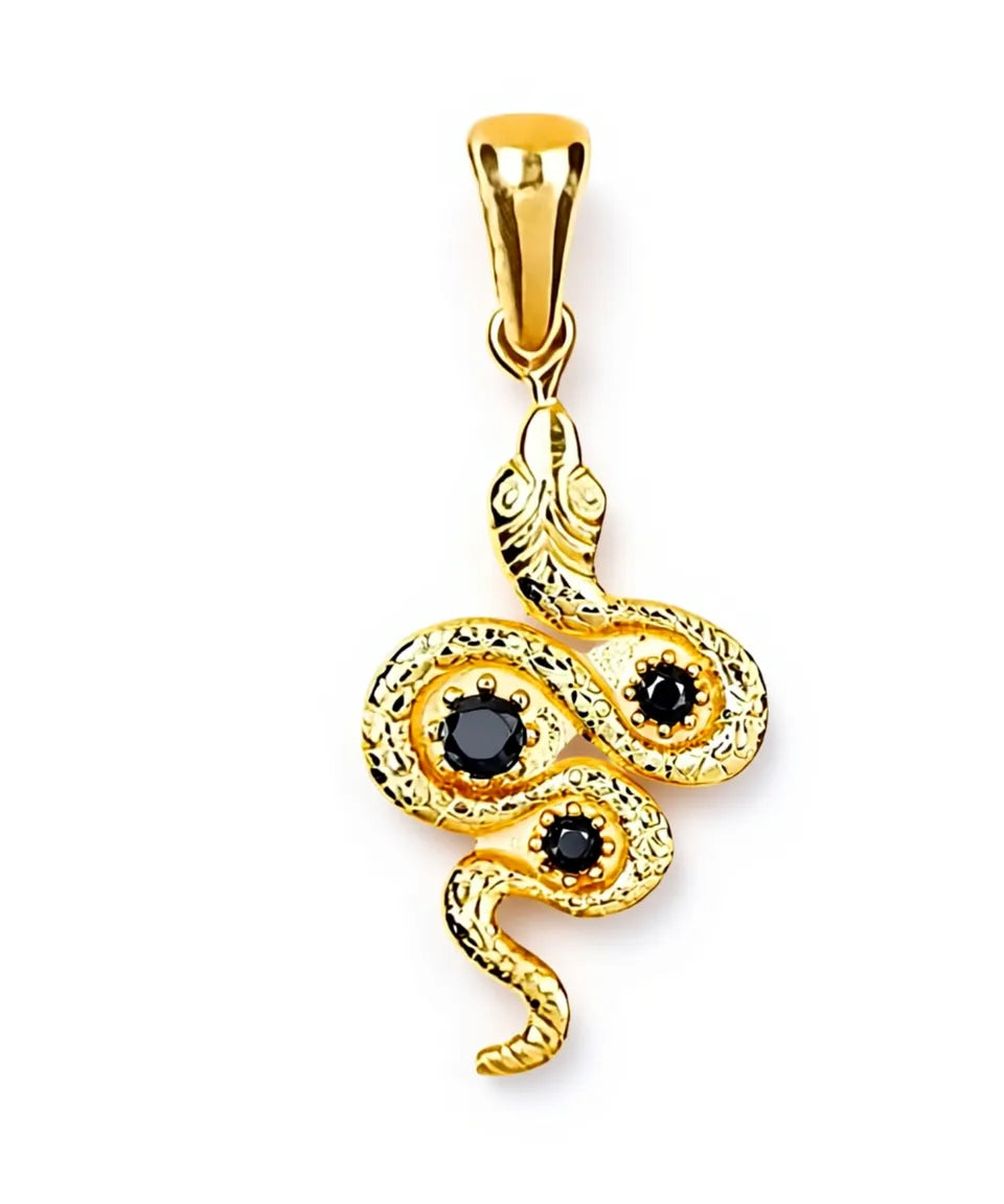 Gold snake-shaped pendant with black stones on a white background