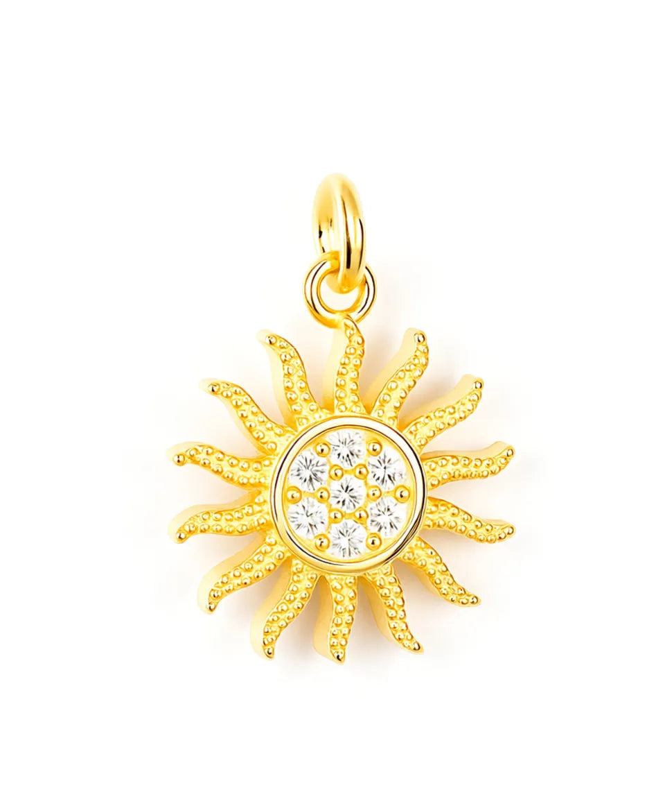 Gold sun-shaped pendant with a central gemstone on a white background