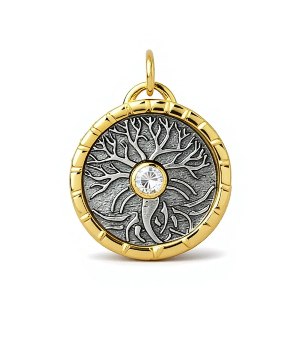 Gold and silver pendant with a central diamond on a white background
