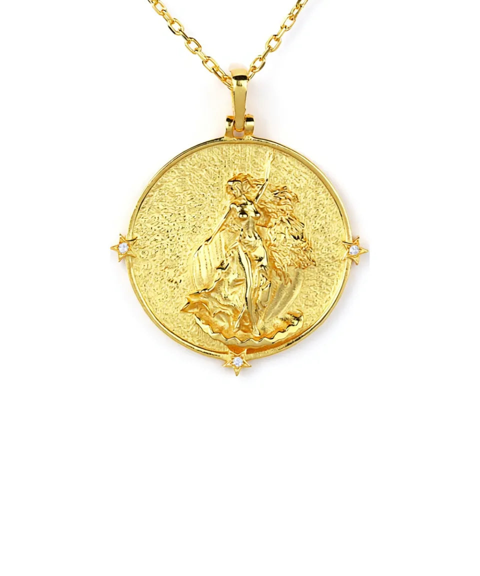 Gold pendant necklace with a religious design on a white background