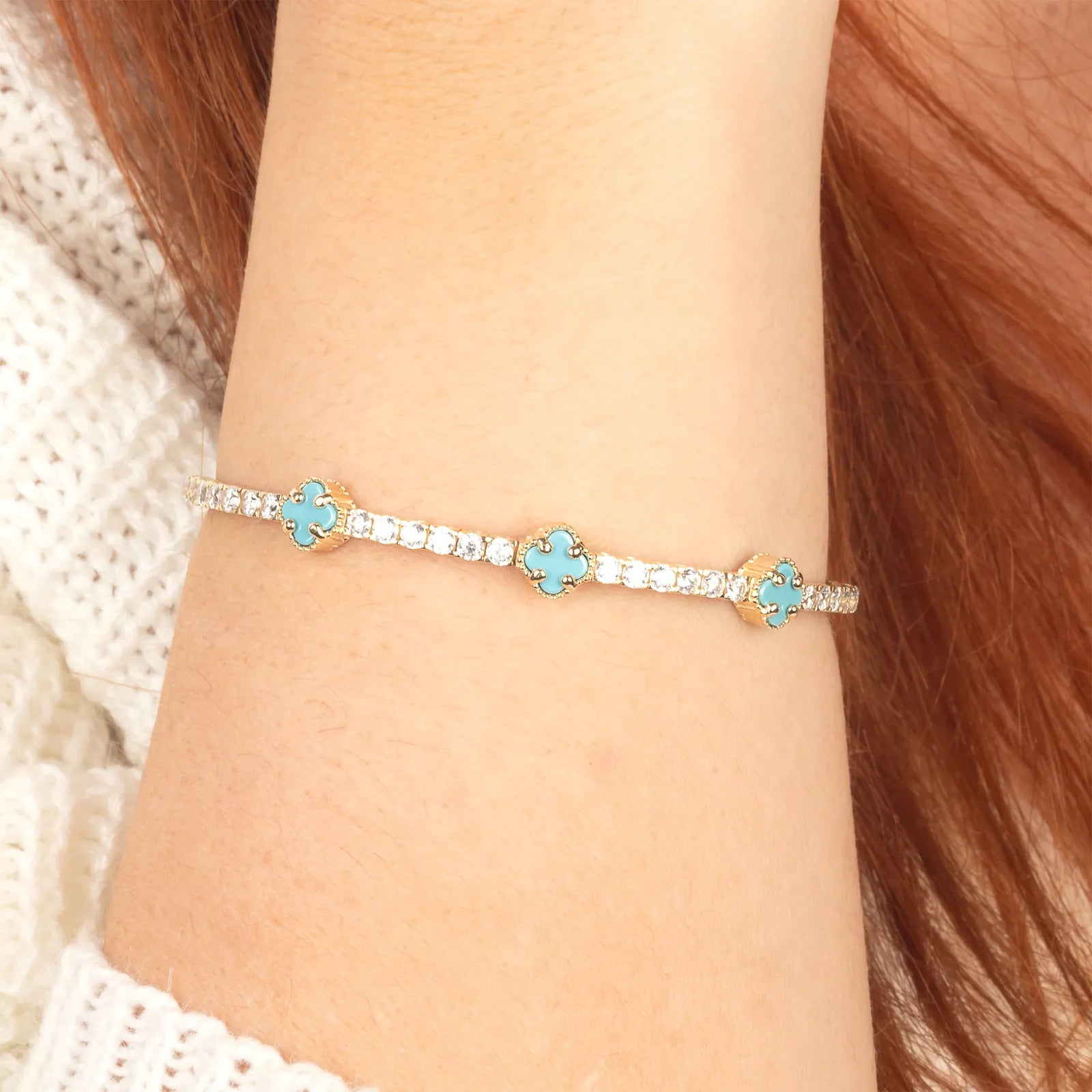 A premium 14K gold bracelet featuring turquoise charms and a flexible, lightweight structure for comfortable wear.