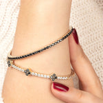 A refined black onyx and moissanite bangle in 14K gold, designed for a sophisticated and classic jewelry statement.