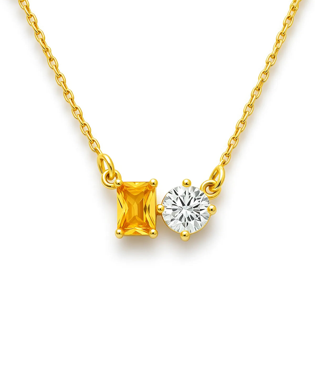 Gold necklace with a yellow gemstone and a round clear gemstone on a white background