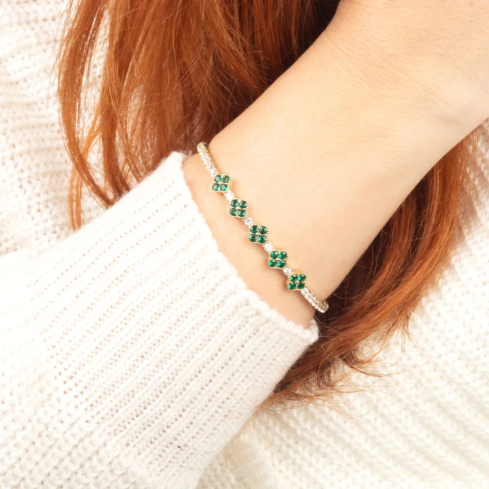 Person wearing a green gemstone bracelet on a white sweater.| MyJewelist