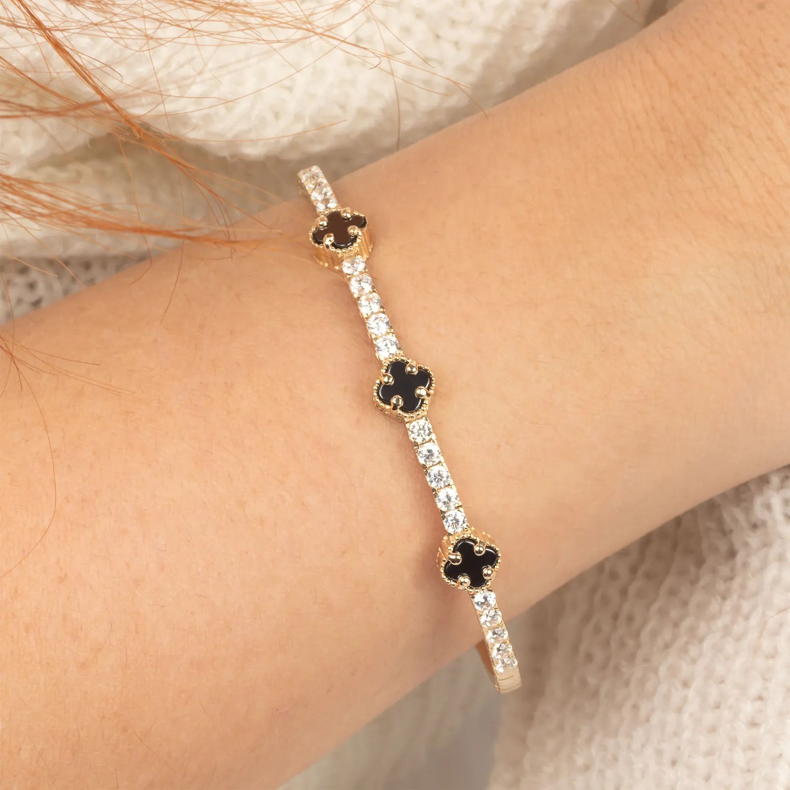 half eternity bangle with onyx clover on the model