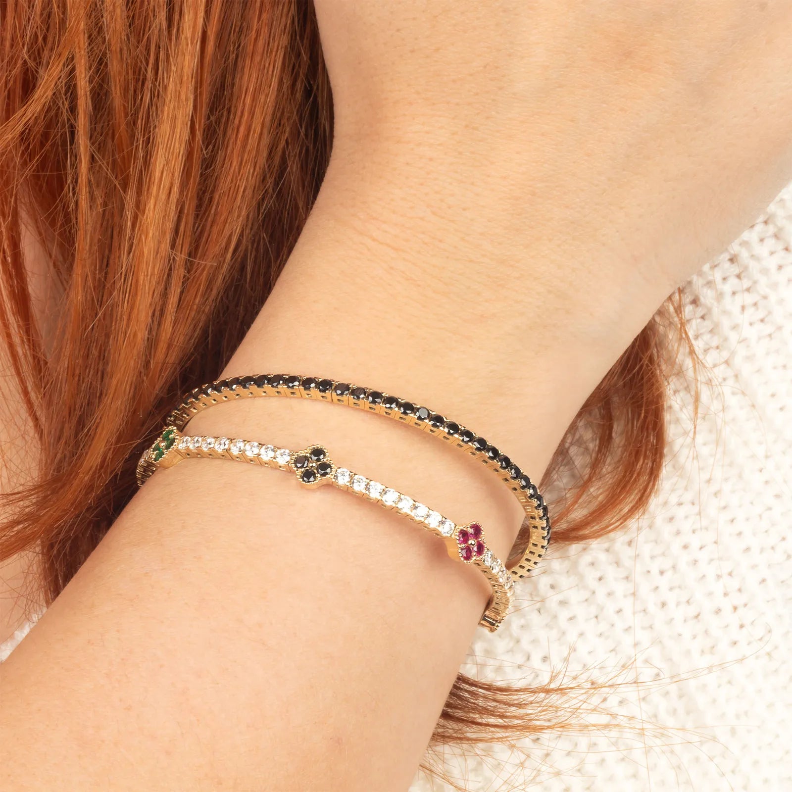 Close-up of a person's wrist with two bracelets on.| MyJewelist